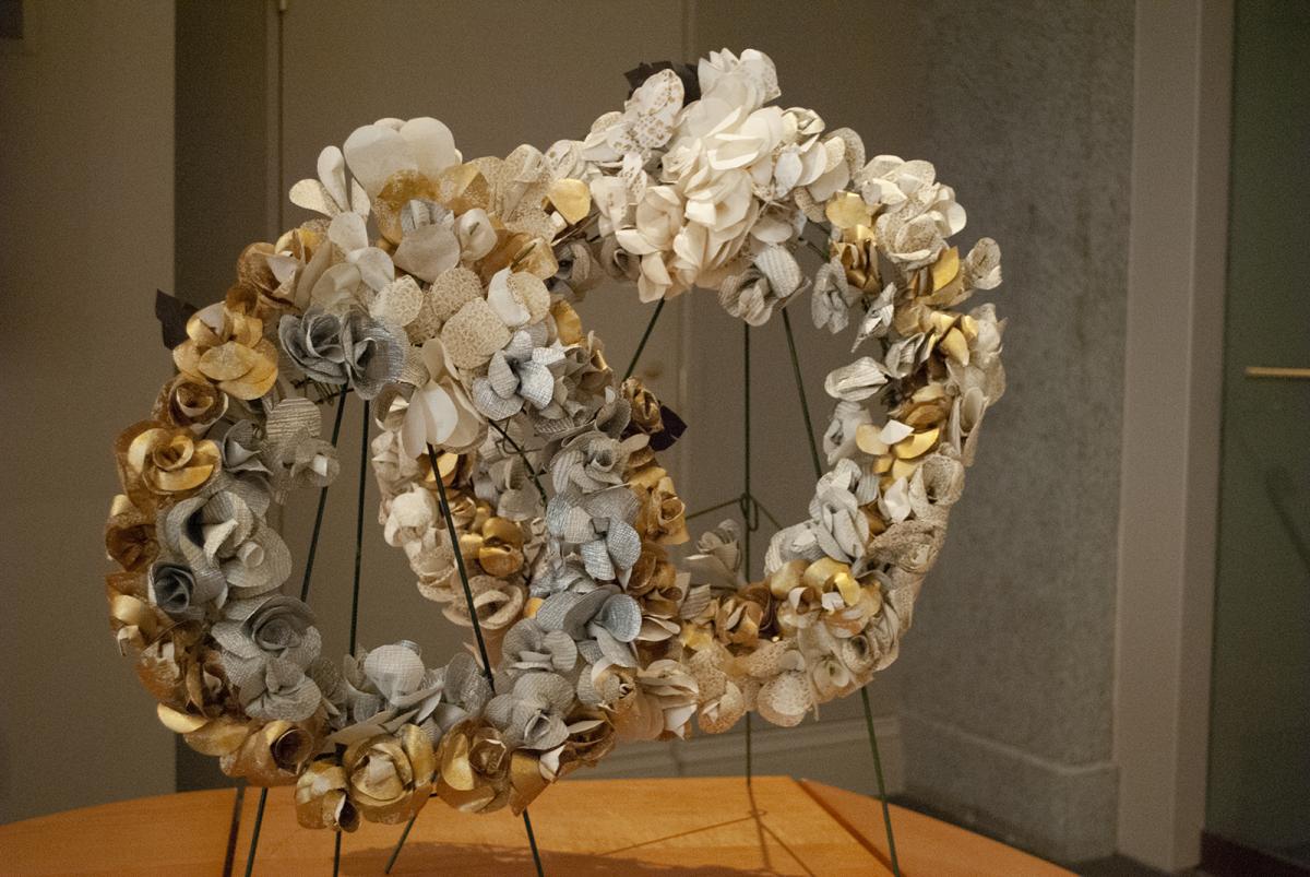 A photograph of two wreaths on a table.