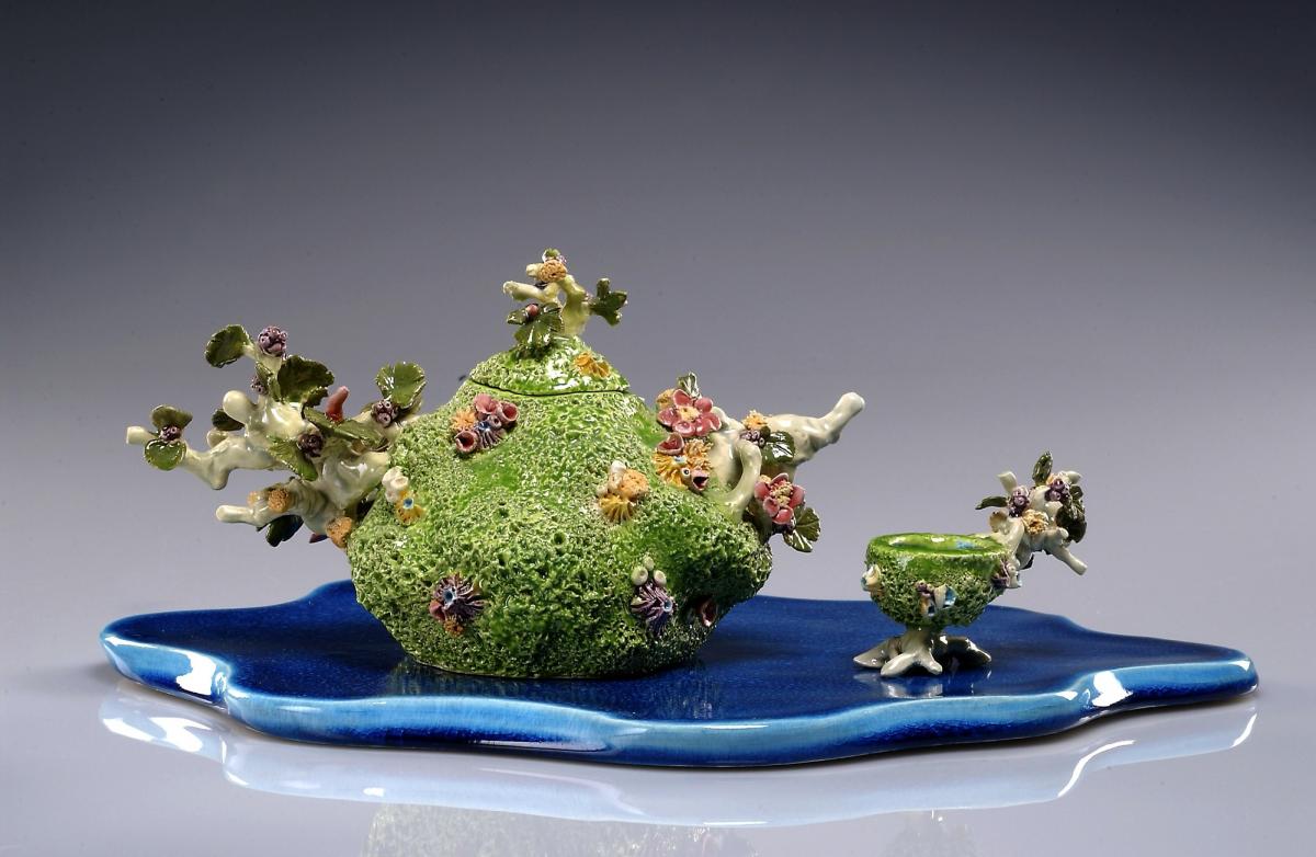 A ceramic tea pot made to resemble a coral reef.