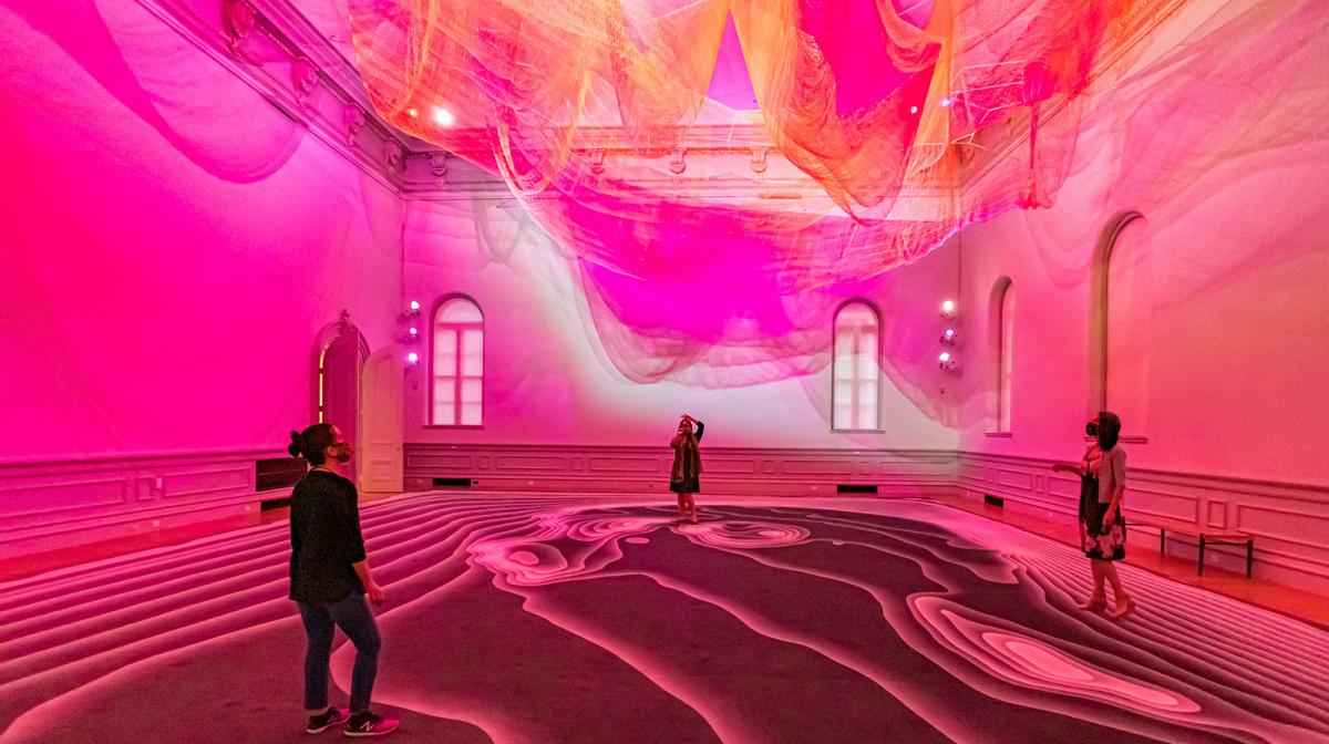 Three people looking up at an art installation inside the Renwick Gallery.