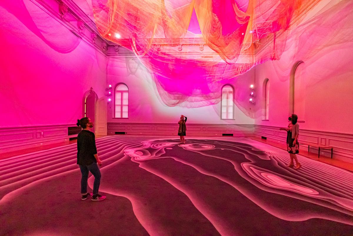 Three visitors viewing the Echelman artwork in the Renwick's Grand Salon