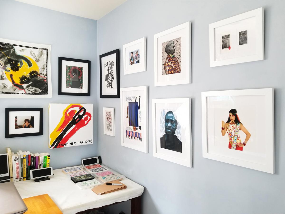 A photograph of a wall with artwork on it. 