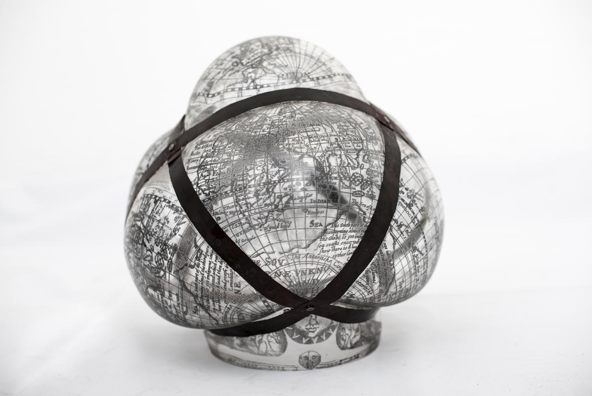 An artwork image of a squished globe with black constraints against it. 