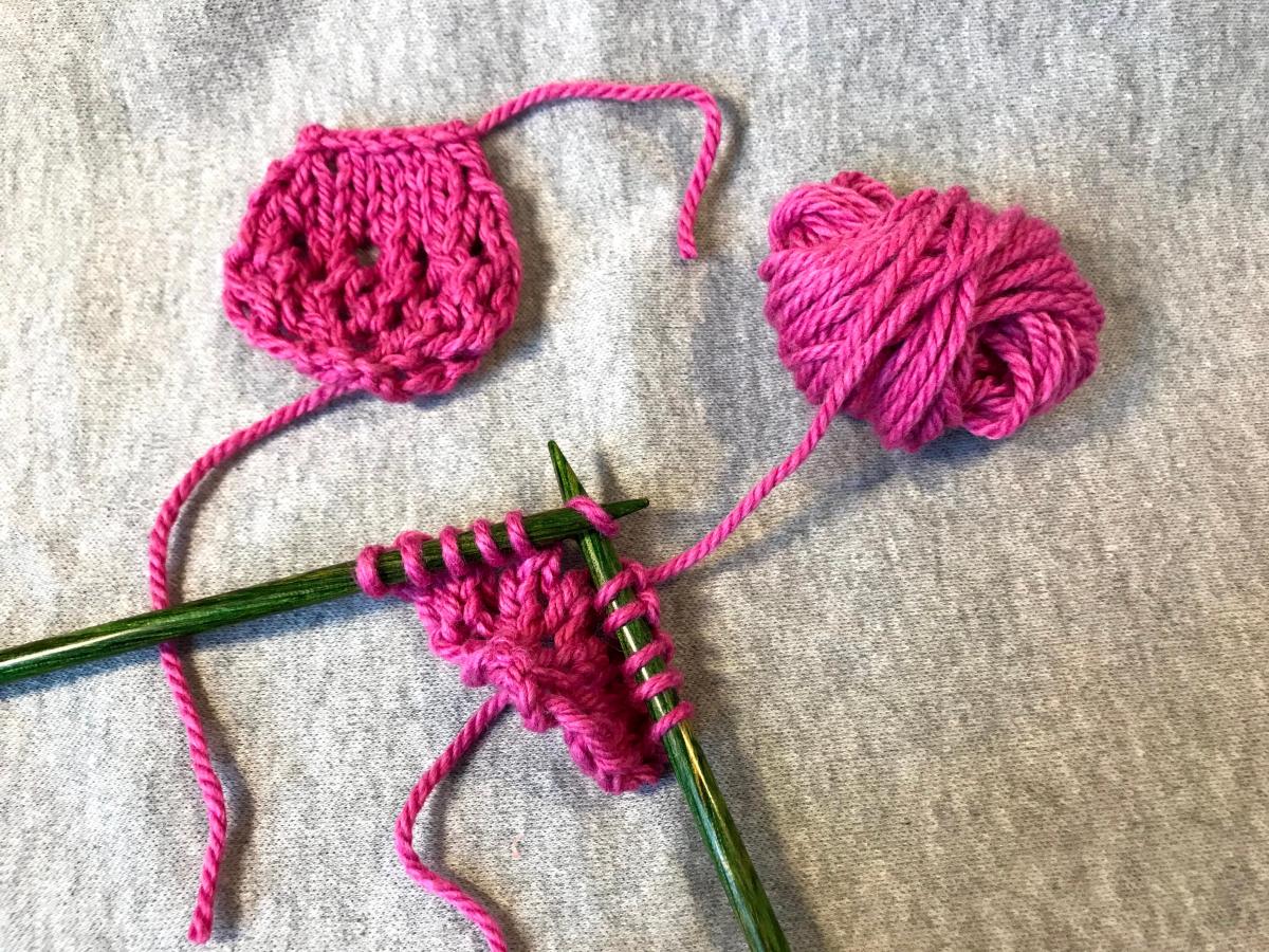 In progress knitting a cherry blossom petal in pink yarn