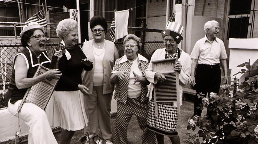 Blog - Joan Netherwood Clark Rememberance, March 202, Fourth of July Celebration Group of senior citizens celebrating Fourth of July in front of a home.