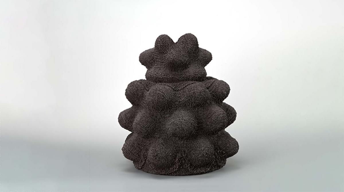 A black ceramic sculpture with texture