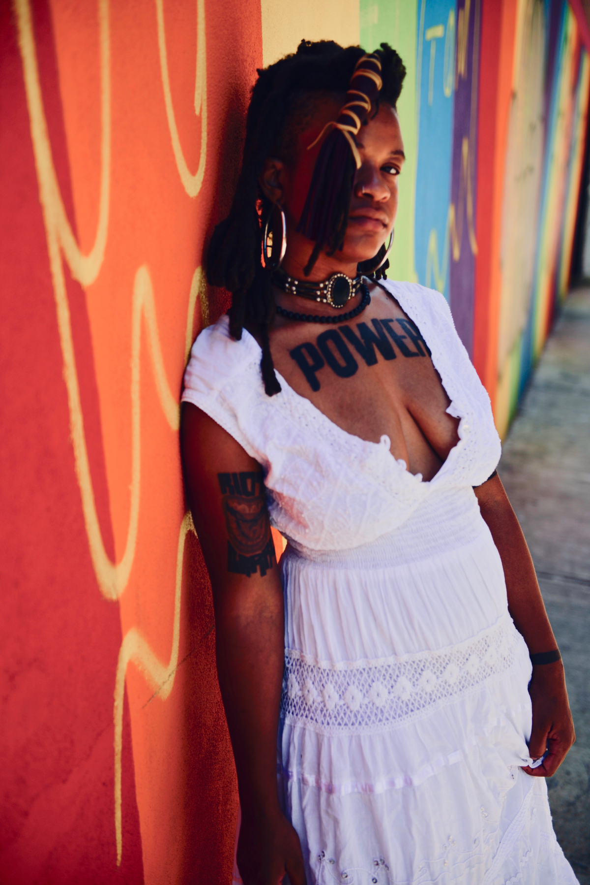 a photo of musician Jenna Camille leaning against a wall