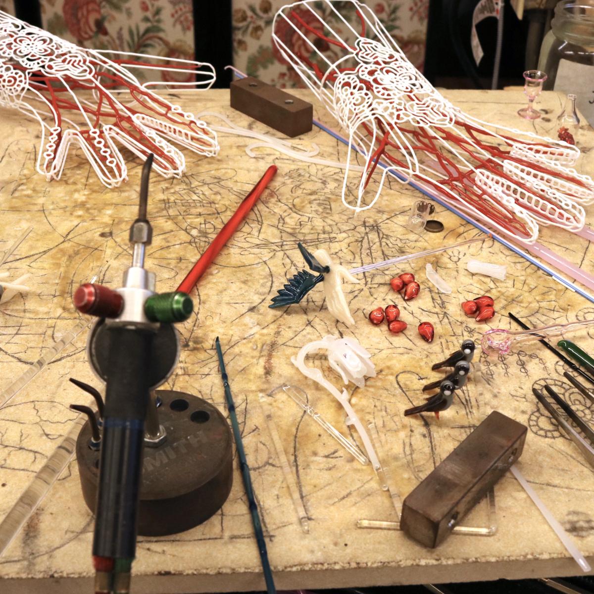 Artist's workspace with mini torch and work supplies