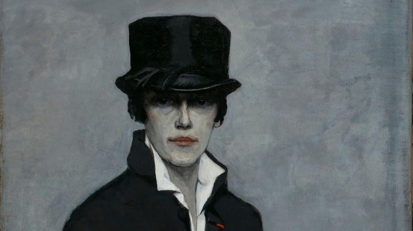 Blog-Romaine-Brooks-portrait-crop Head of Romaine Brooks wearing a hat, coat, and white shirt open at the collar.