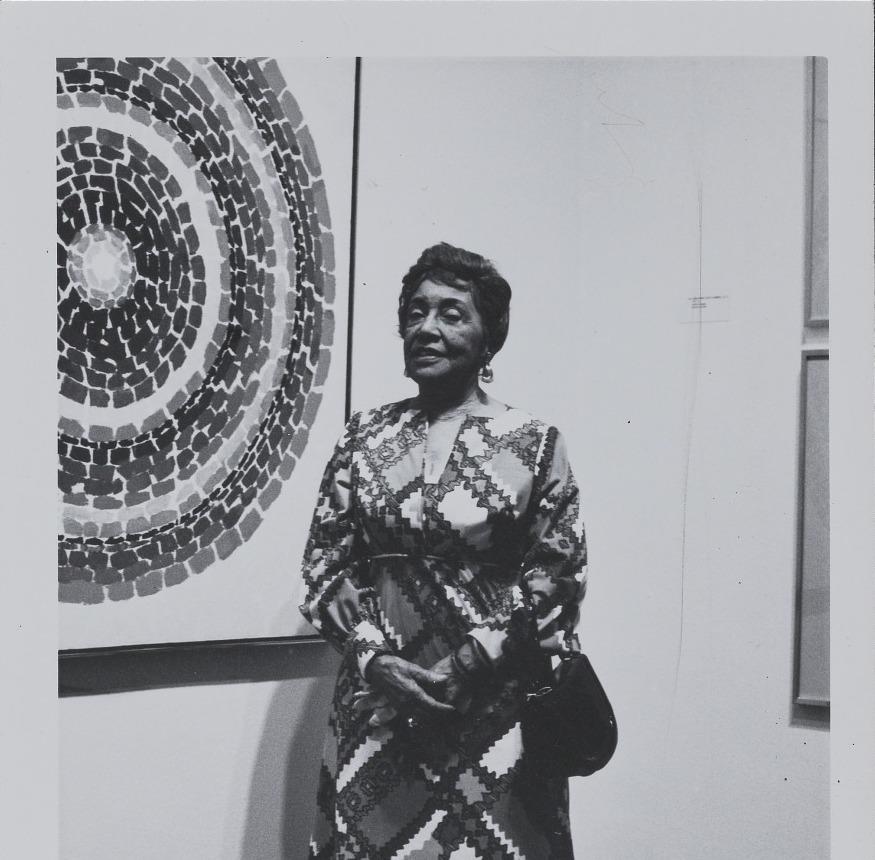 Painter Alma Thomas in front of one of her paintings in 1972