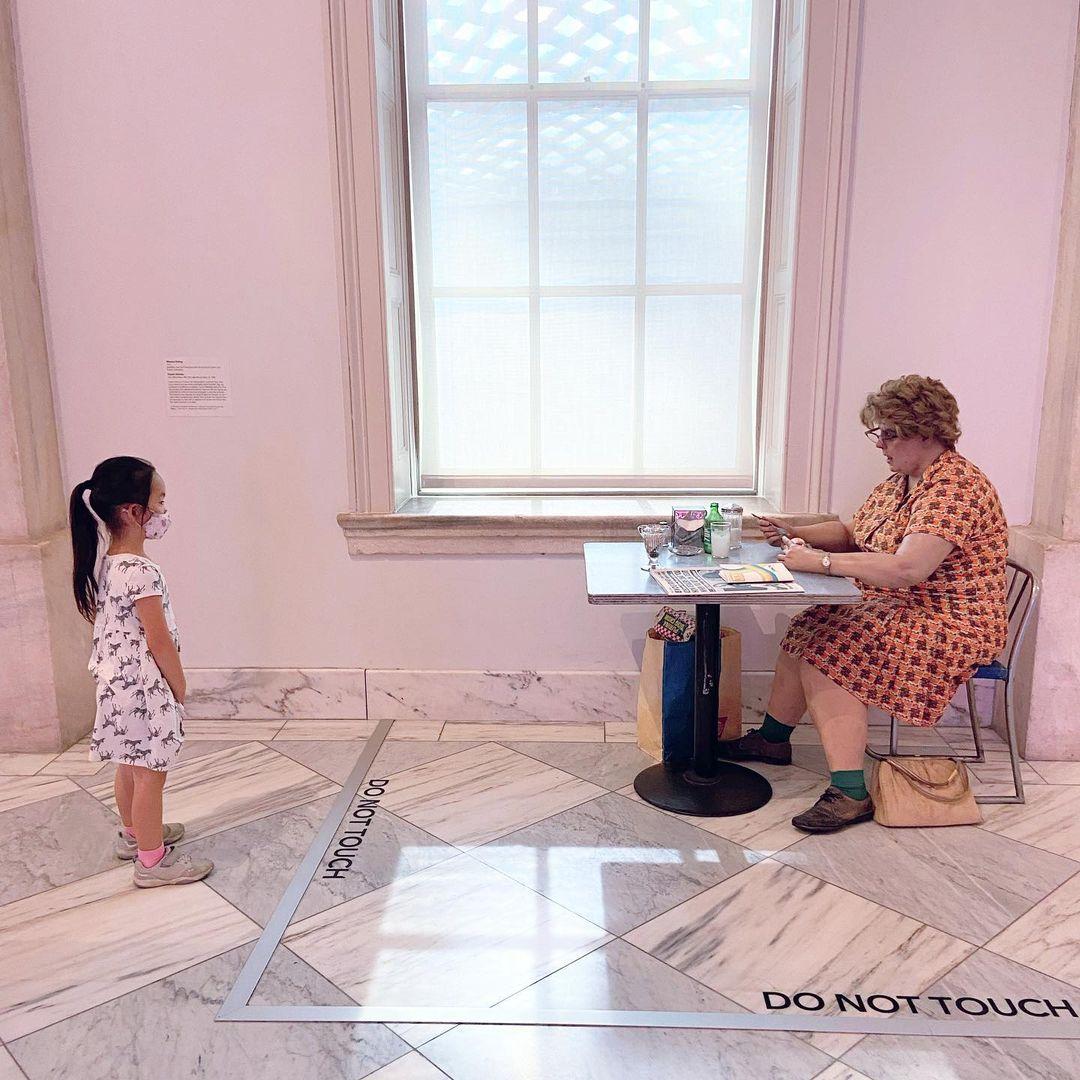 Small child looking at Woman Eating