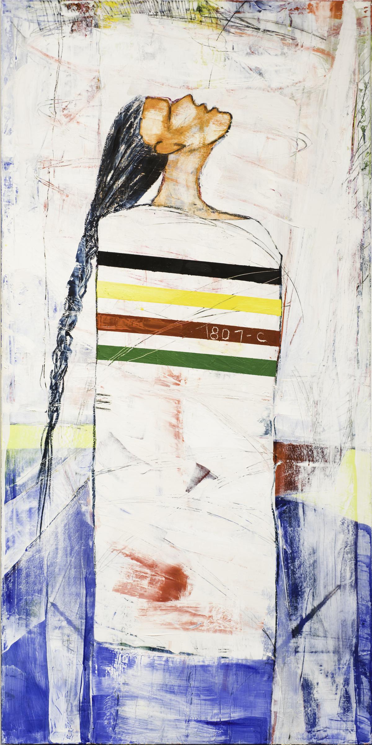 Native woman wrapped in a blanket with a green red yellow and black stripes