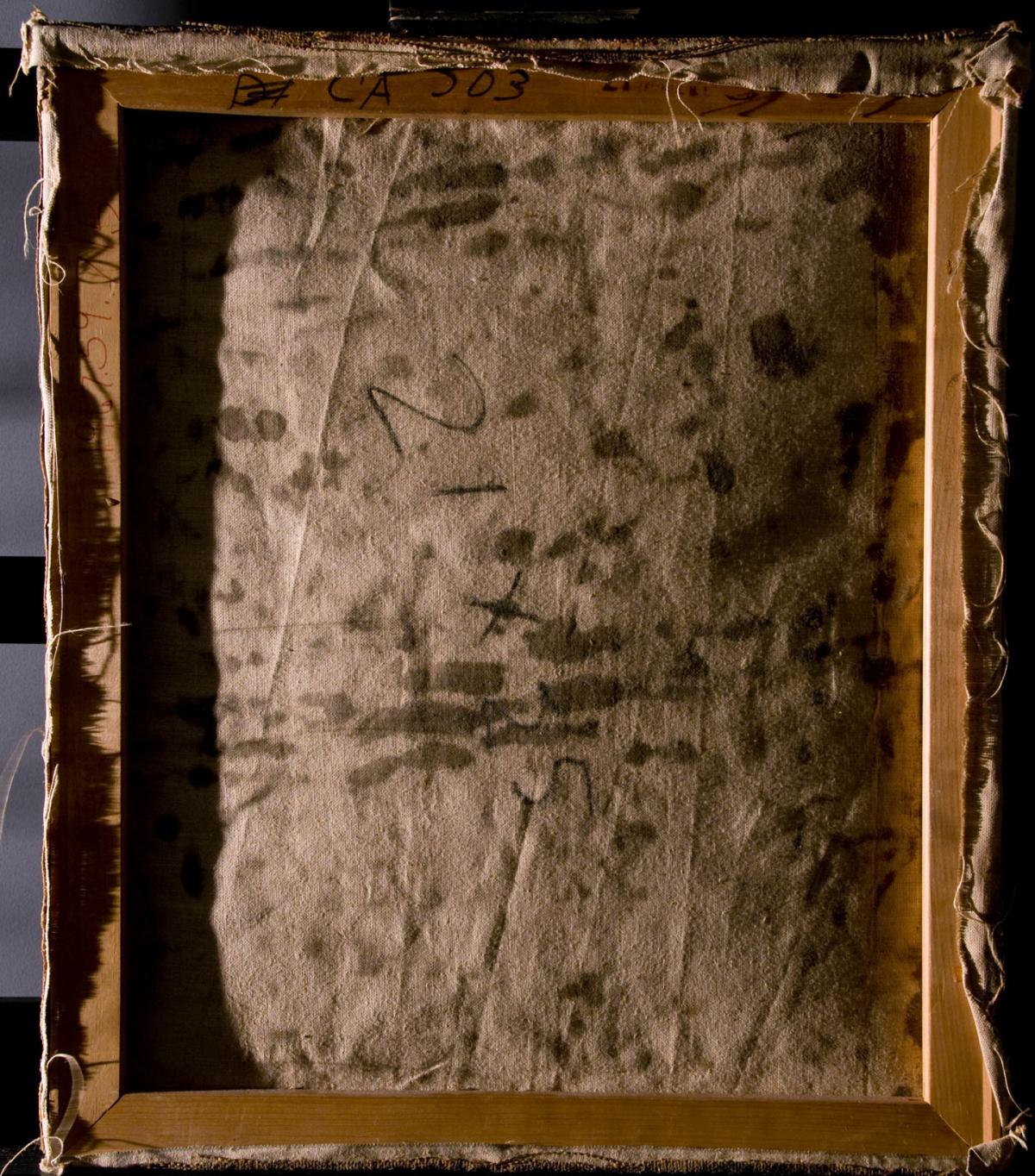 The back of a damaged painting shows staining before conservation