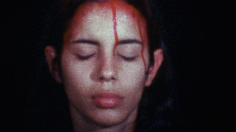 Portrait of a woman with blood dripping form her head. 