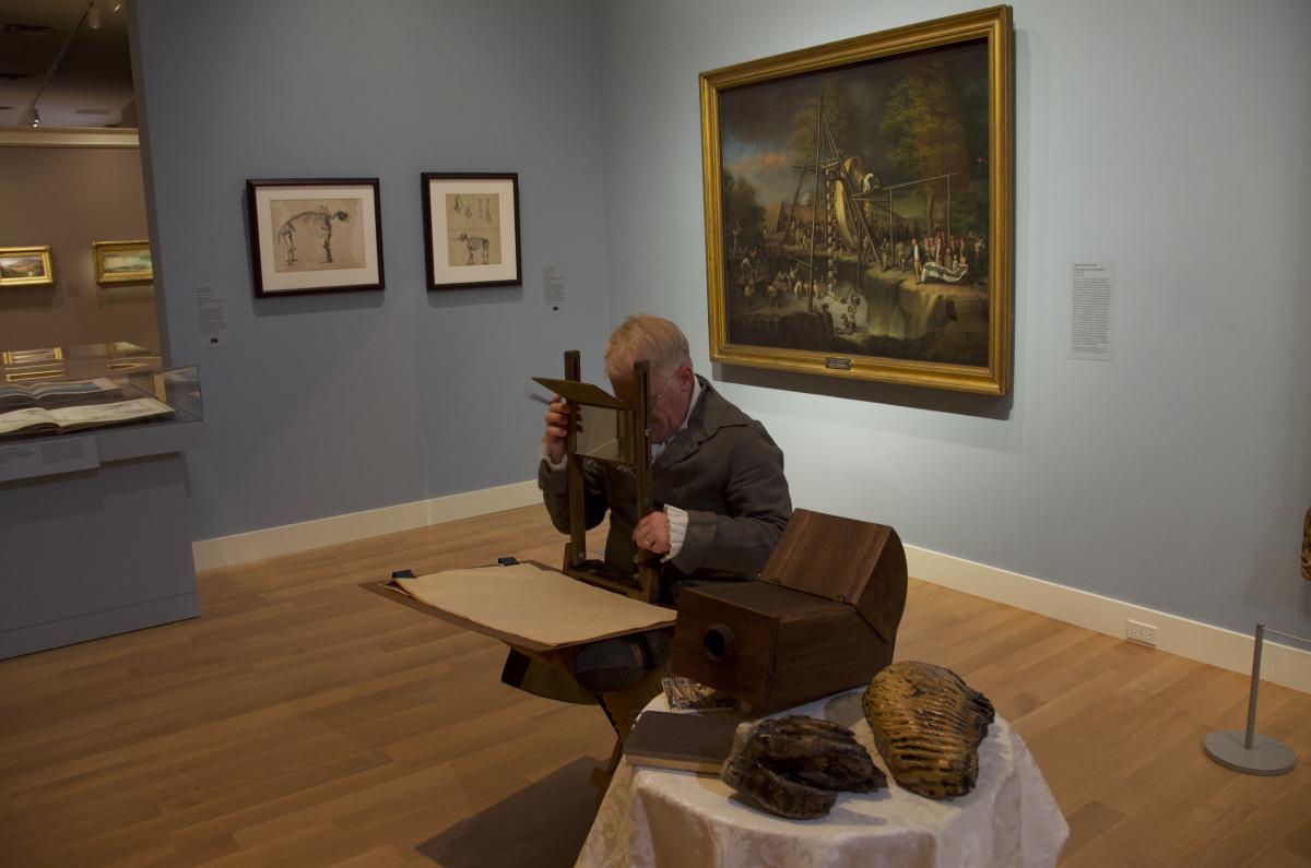 Image of a man using a camera lucida