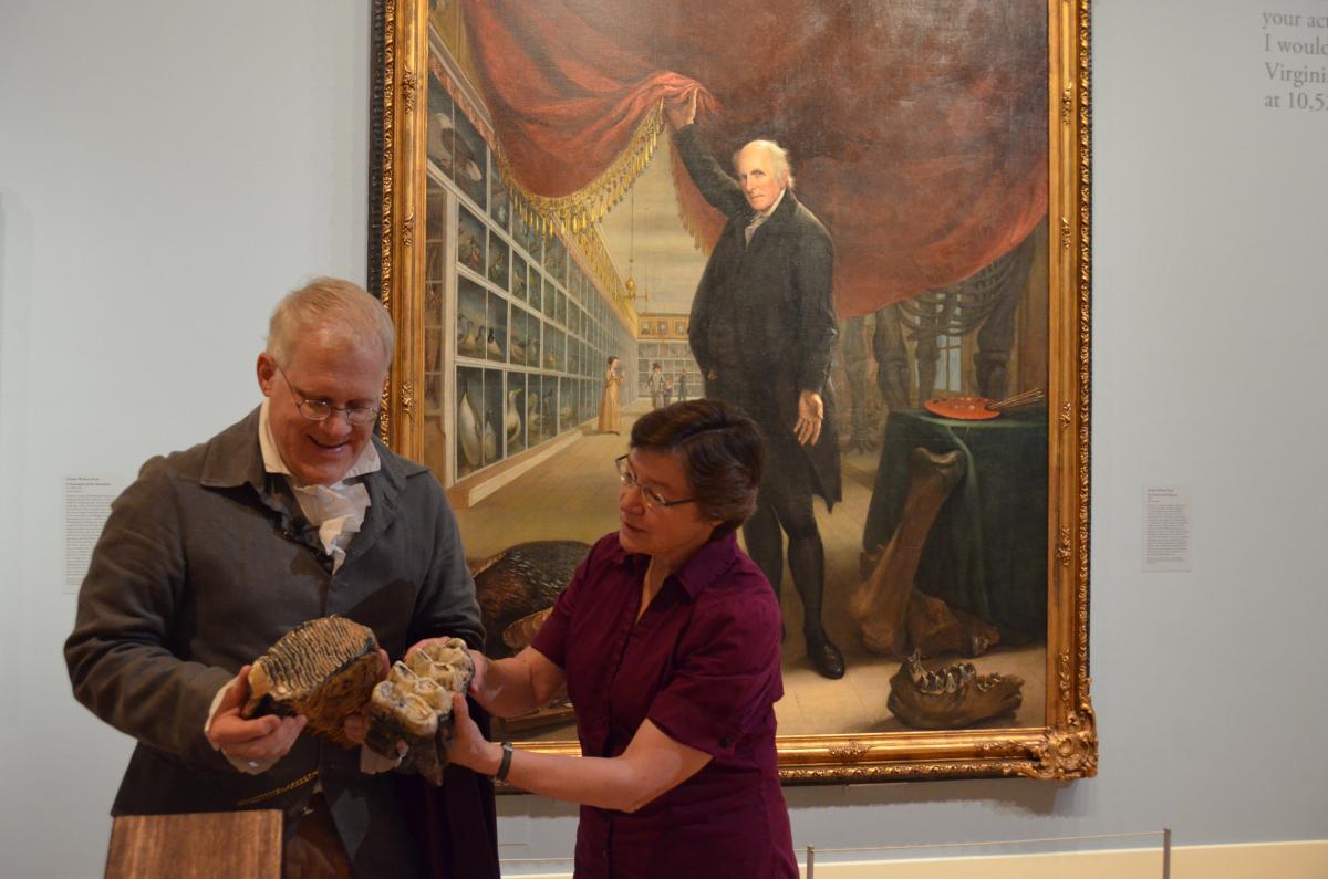 Image of two people looking at Mastodon bones