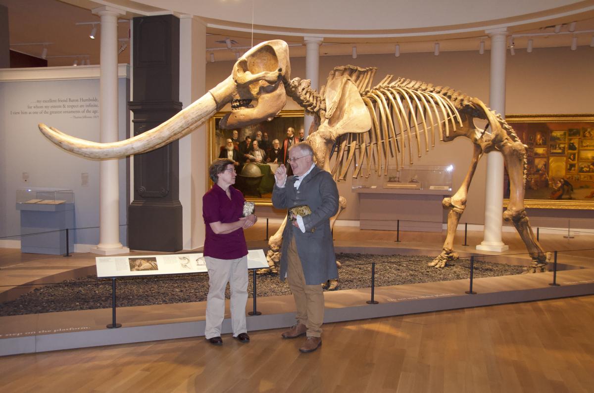 Image of two people in front of Mastodon skeleton