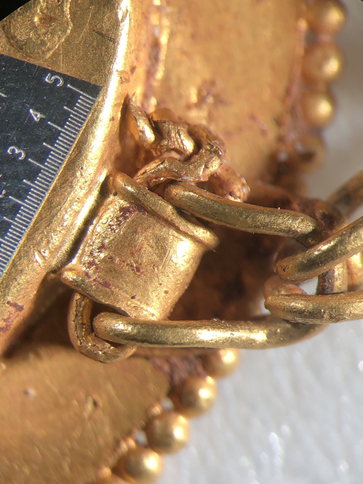 Close up of intricate chain on gold necklace