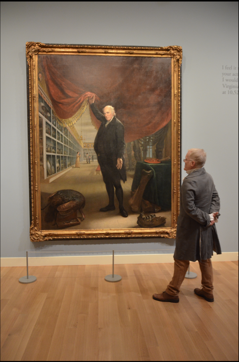 man looking at portrait of Charles Willson Peale 