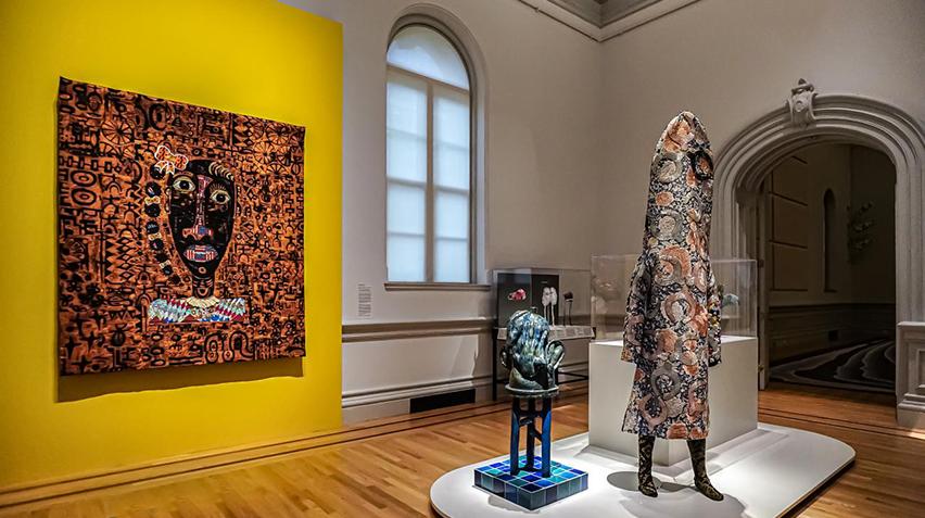 Gallery view of quilt and ceramic sculptures