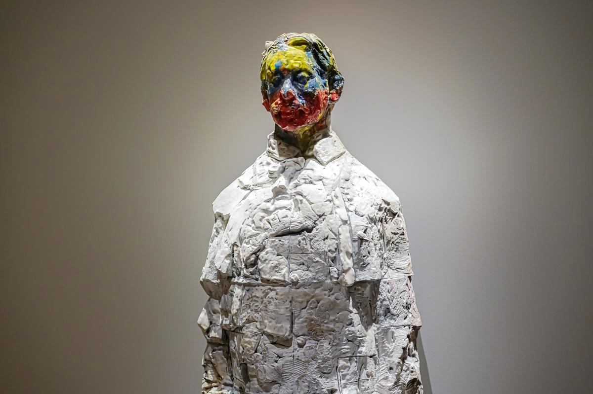 Close of up of clay statue with painted face