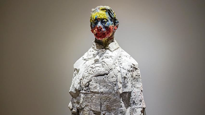 Close of up of clay statue with painted face