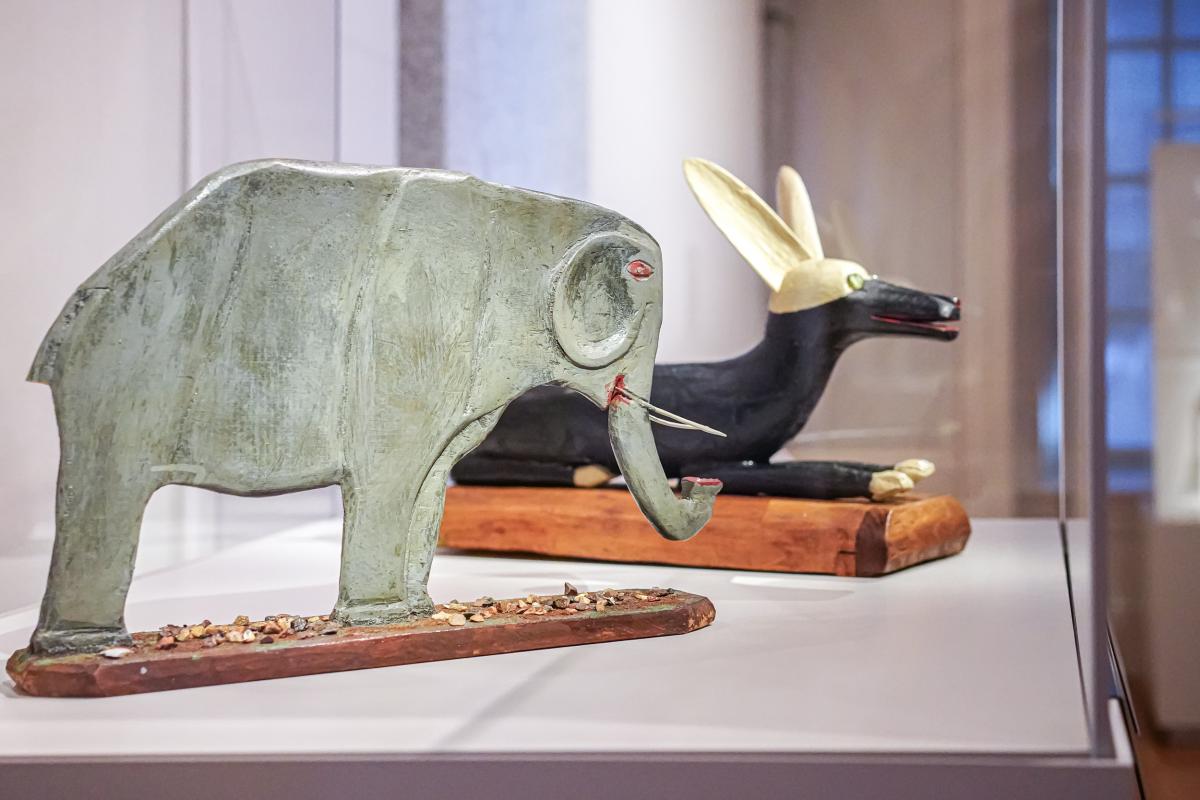 Installation pairing of a wooden elephant and dog