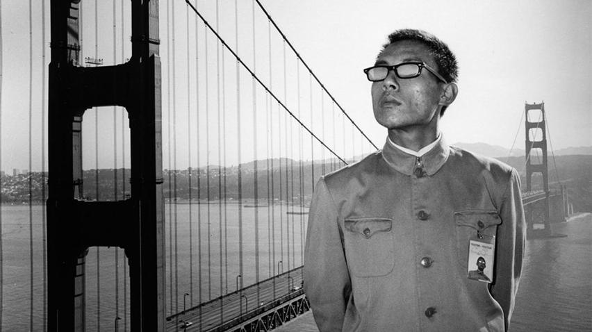 Blog - Tseng Kwong Chi, home page crop A man in a Mao suit standing in front of the Golden Gate Bridge