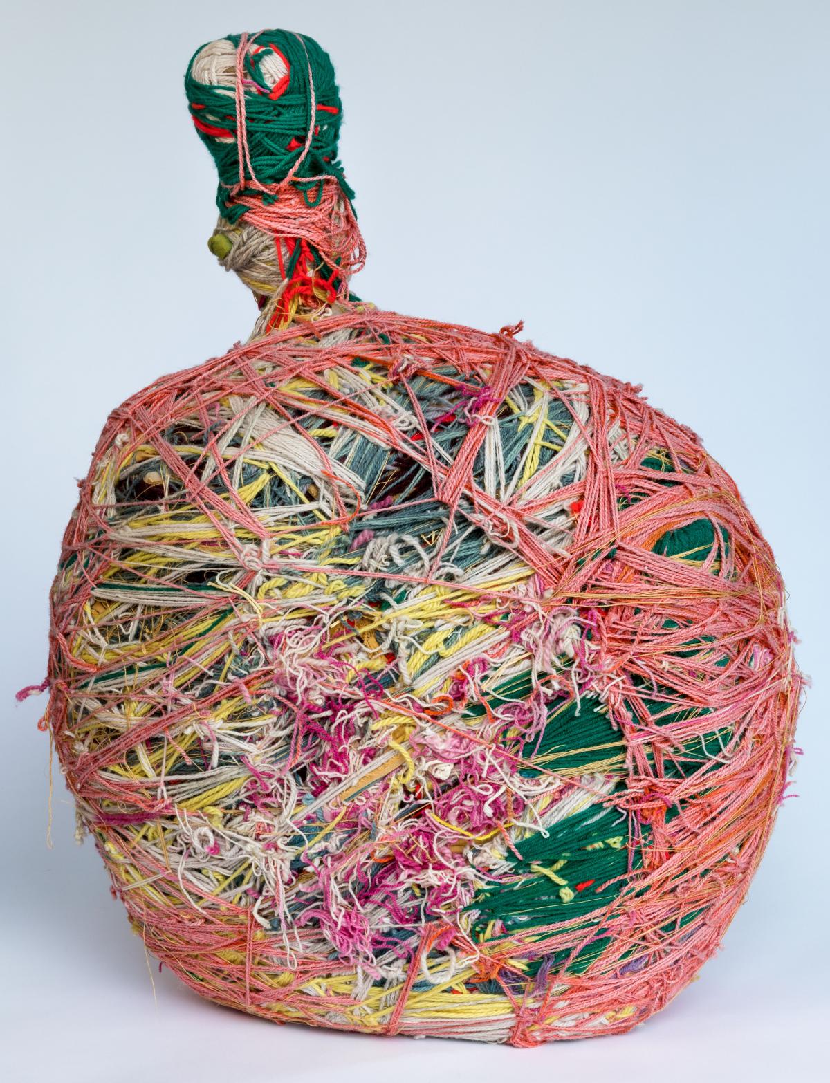 A bottle wrapped in colorful threads 
