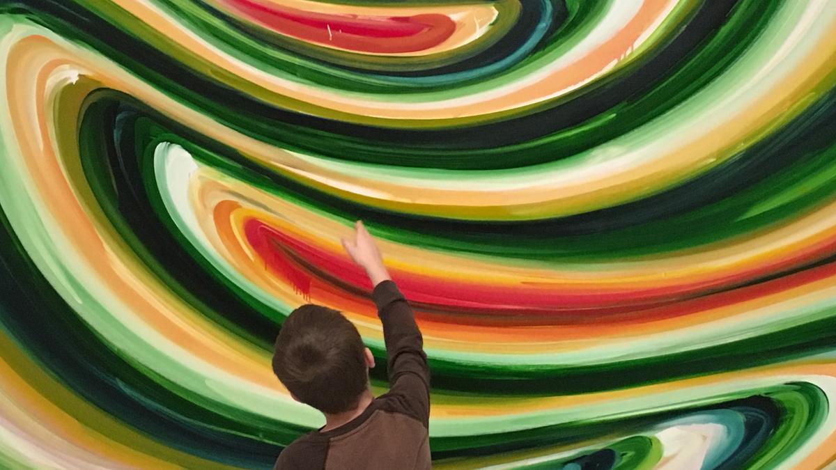 A child points at a painting