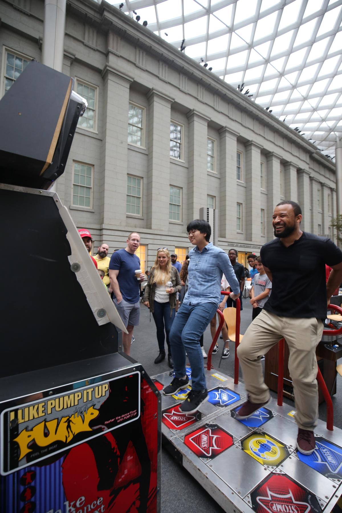 People in front of a video game console. Participants are moving their bodies to control the game. 