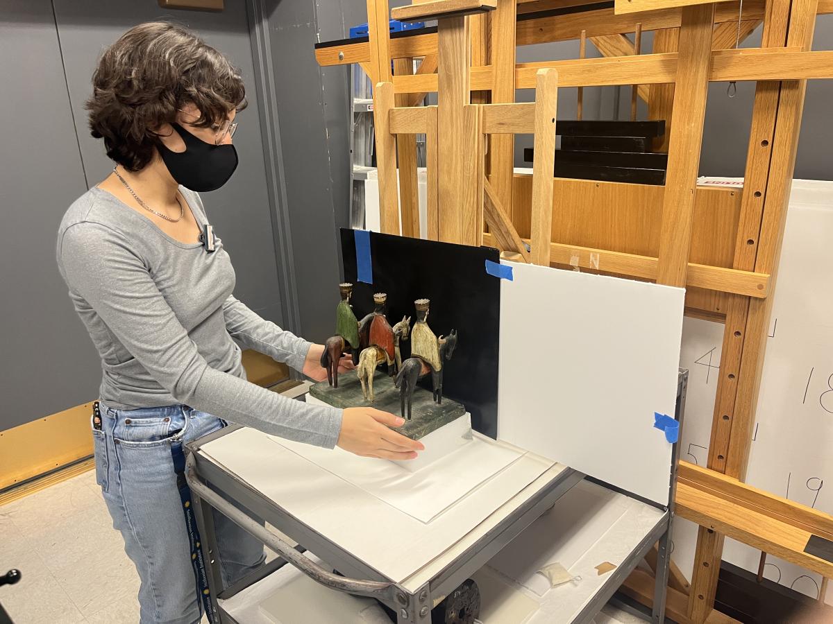  A woman in a gray sweater prepares objects for x-radiography in Lunder Conservation Center.
