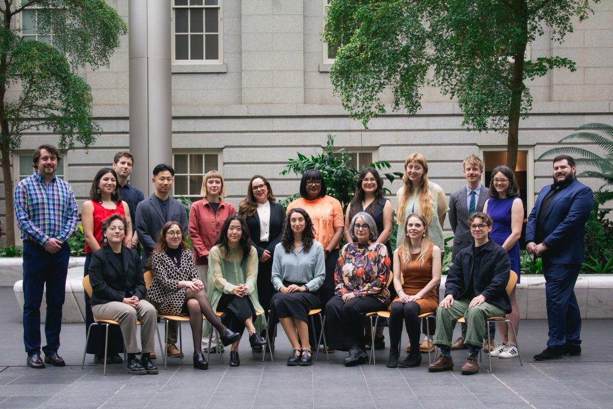 Group of nineteen people in a courtyard