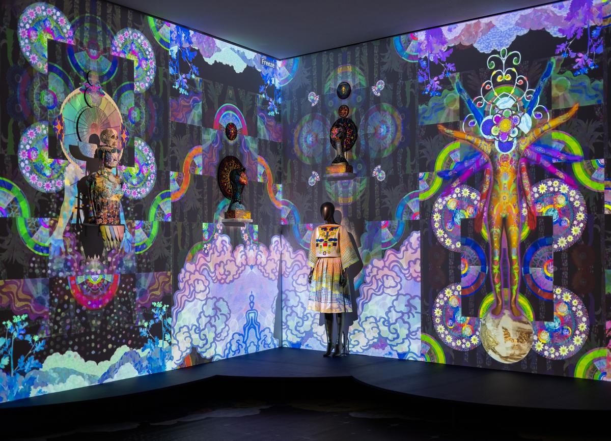 Multimedia art installation with kaleidoscopic projections and mannquins.