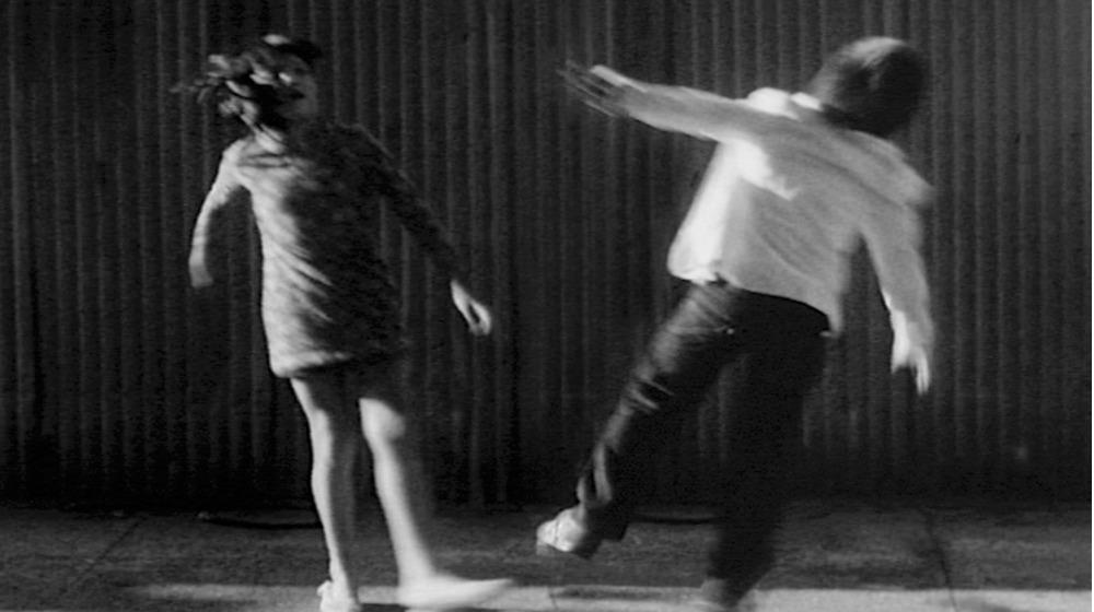 Black and white Image of boy and girl with back to camera blurred 