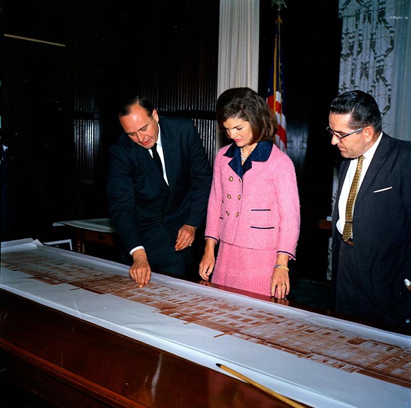 Jackie Kennedy looking at architectural drawings