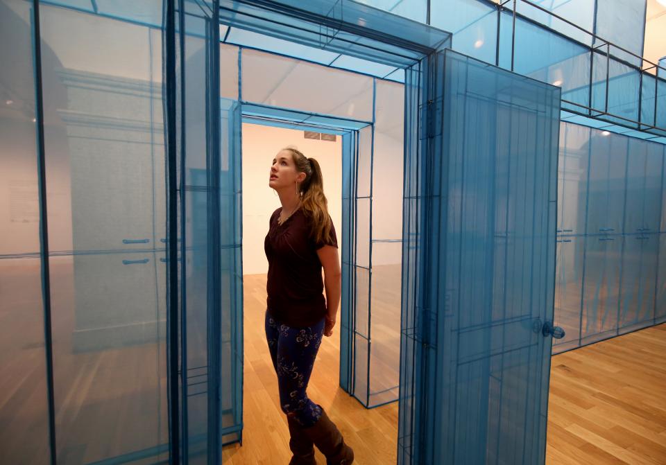 Exhibition Do Ho Suh Almost Home 4 Libby Woman standing next to blue hub sculpture