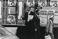 A photograph of Malcolm X on the street. 
