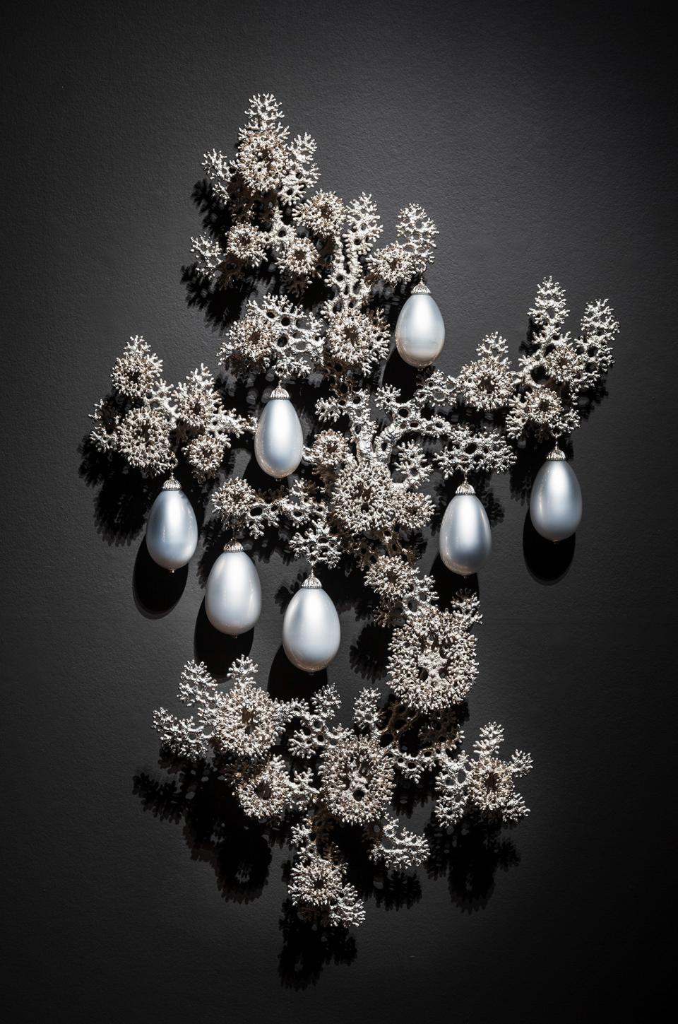 abstract shapes painted in silver with seven silver ornaments.