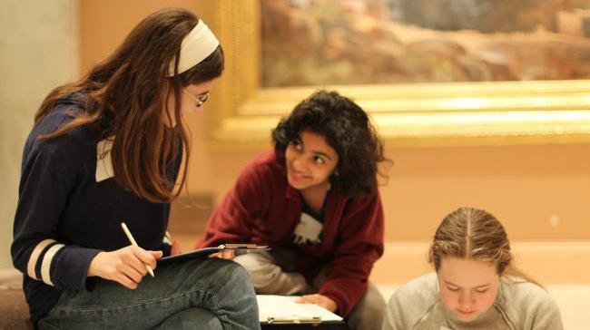 Two students talking to one another. 