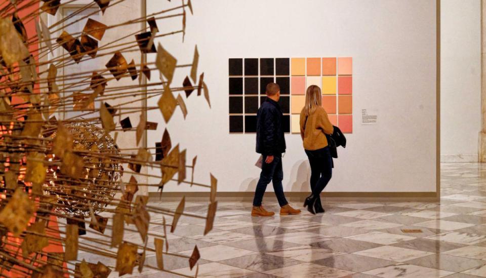 A photograph of two people in an art gallery