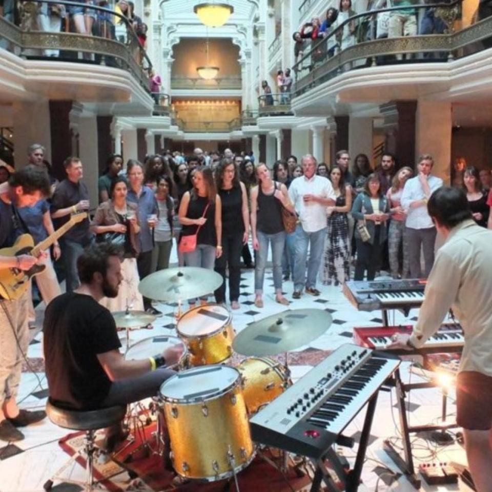 Musicians preforming to a crowd of people in the Luce Foundation Center