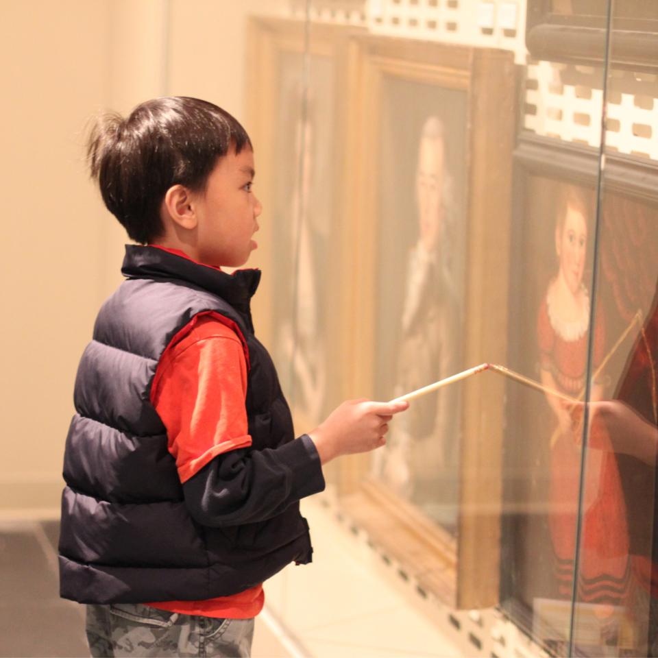 A boy doing a scavenger hunt at the Luce Foundation Center.