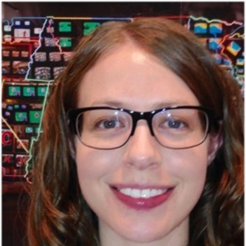 A photograph of Anne Showalter in front of Superhighway. 