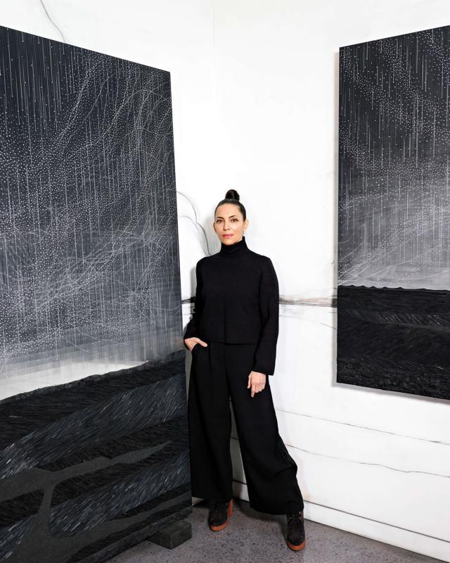 Bio Image - Teresita Fernández Teresita Fernández poses between two of her artworks.