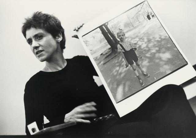 photo of Diane Arbus holding one of her photos.