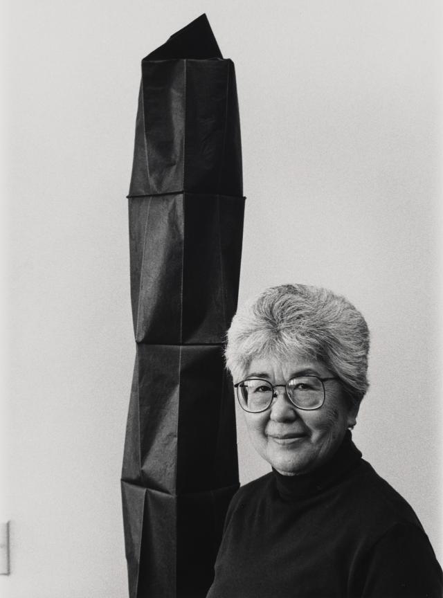 photo of person infront of their artwork