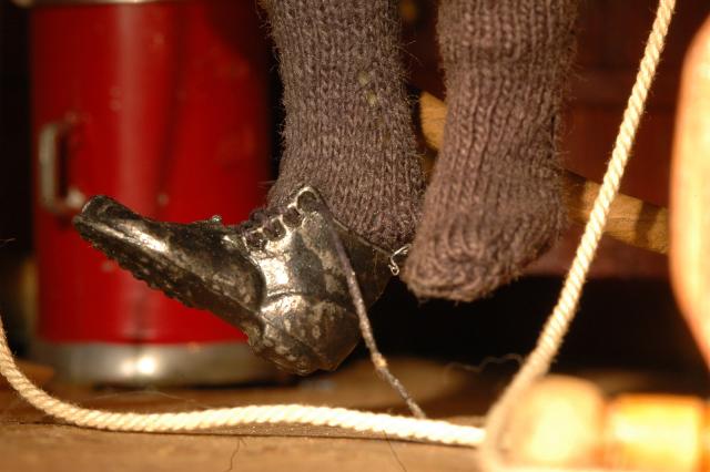 A photograph of a nutshell study of unexplained death showing a detail of a shoe.