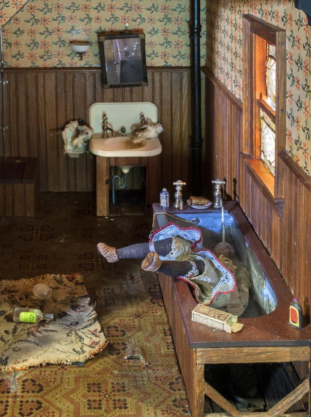 A photograph of a nutshell study of unexplained death showing a detail of a woman's death inside a bathtub.