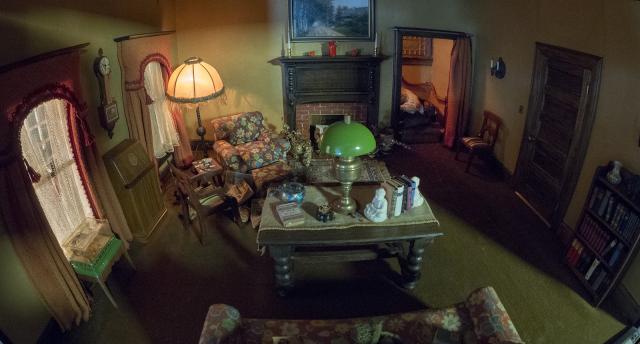 A photograph of a nutshell study of unexplained death showing a detail of a a living room.
