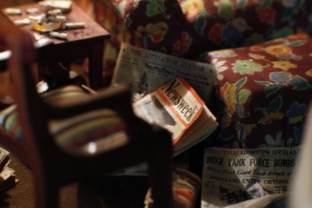 A photograph of a nutshell study of unexplained death showing a detail of a living room.